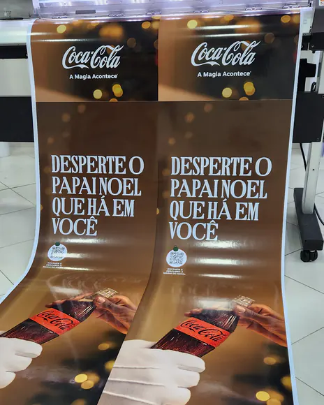 Banners de Natal da Coca-Cola saindo da impressora